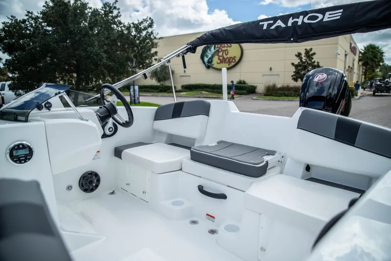 Slide: The Image of 2027 Tahoe T18 boat interior with steering wheel, seating, and outboard motor. - 11