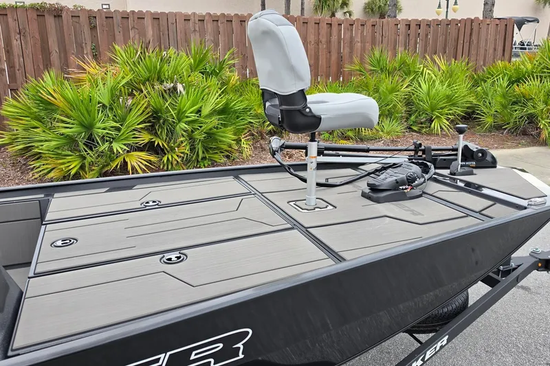 Slide: The Image of 2027 Tracker Pro 170 boat with elevated seat and trolling motor, surrounded by lush greenery. - 19