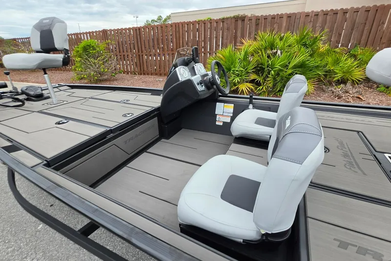Slide: The Image of 2027 Tracker Pro 170 boat interior with gray seating and steering console. - 20