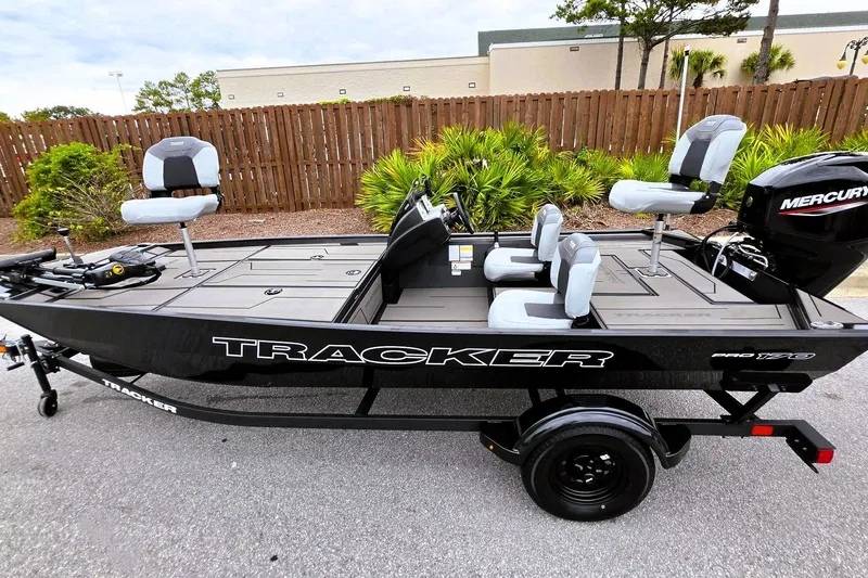 Slide: The Image of 2027 Tracker Pro 170 fishing boat with Mercury engine, parked outdoors. - 14