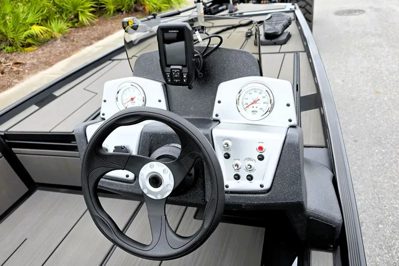 Slide: The Image of 2027 Tracker Pro 170 boat dashboard with steering wheel and gauges. - 16