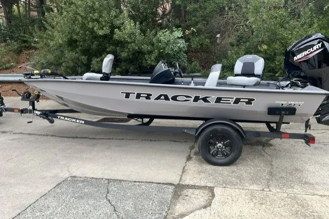 The Image of 2027 Tracker Pro Team 175 boat on trailer, parked outdoors. - 0