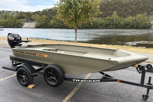 The Image of 2027 Tracker Grizzly 1553 Timber boat on trailer by a scenic river. - 0
