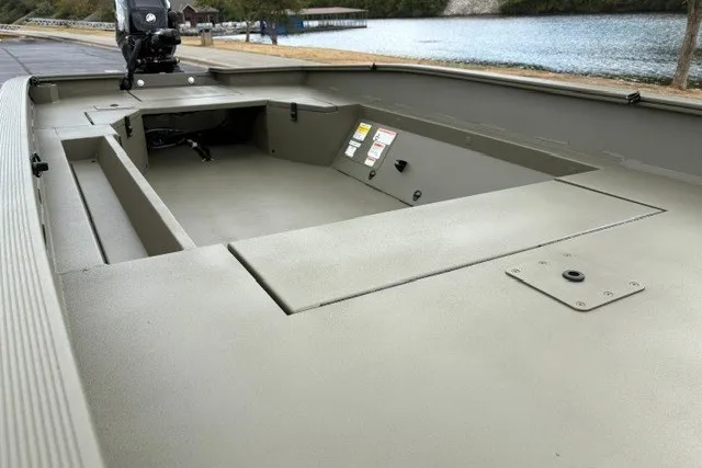 Slide: The Image of 2027 Tracker Grizzly 1553 Timber boat interior, featuring spacious deck and storage compartments. - 17
