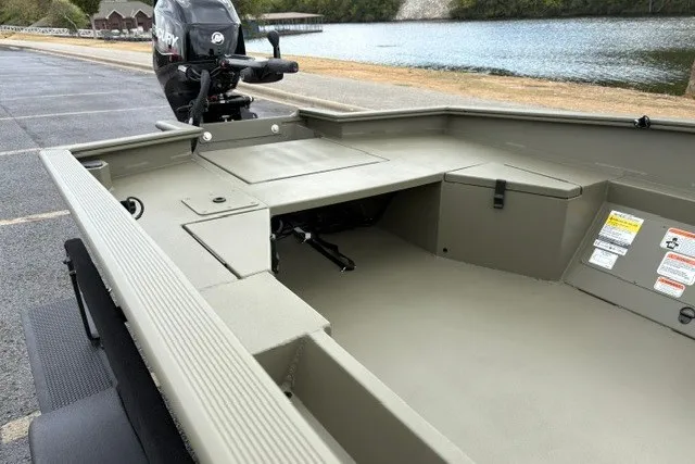 Slide: The Image of 2027 Tracker Grizzly 1553 Timber boat interior near a serene lake. - 16