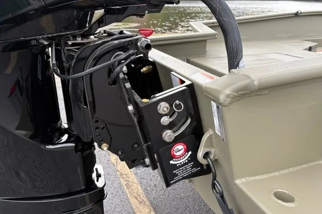 Slide: The Image of 2027 Tracker Grizzly 1553 Timber boat motor mount detail by the water. - 20