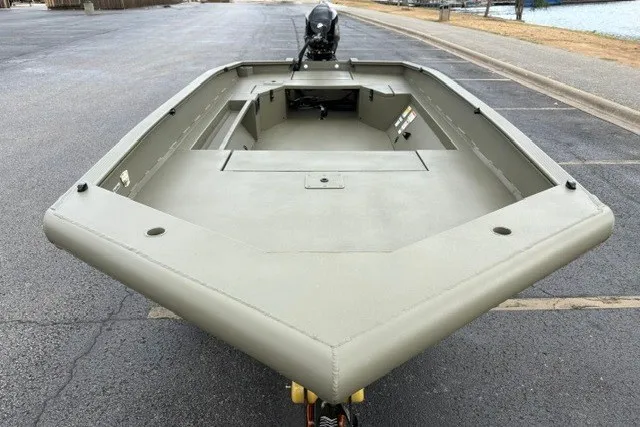 Slide: The Image of 2027 Tracker Grizzly 1553 Timber boat, empty deck view, parked on asphalt near water. - 15