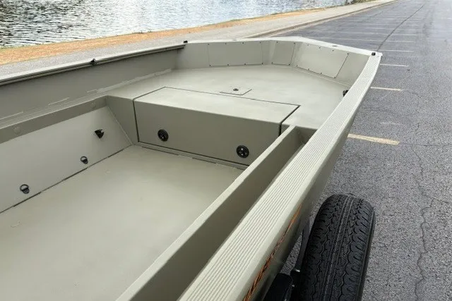 Slide: The Image of 2027 Tracker Grizzly 1553 Timber boat on trailer by waterfront. - 14