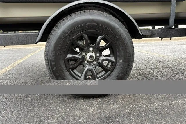 Slide: The Image of Trailer wheel of 2027 Tracker Grizzly 1553 Timber on asphalt. - 24