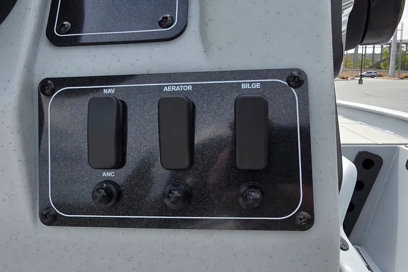 Slide: The Image of Control panel of 2027 Tracker Bass Tracker Classic CC boat with switches for navigation, aerator, and bilge. - 19