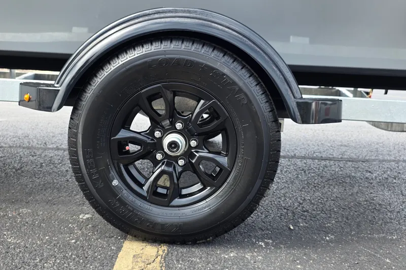 Slide: The Image of Trailer wheel of 2027 Tracker Bass Tracker Classic CC on asphalt. - 20
