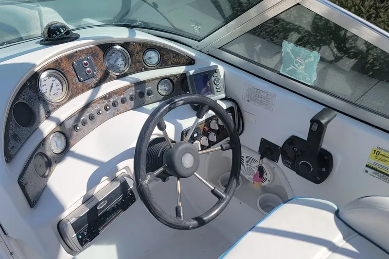 Slide: The Image of 2001 Hurricane SunDeck 217 OB boat dashboard with steering wheel and gauges. - 18