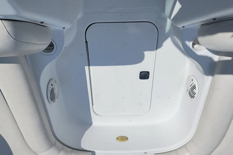 Slide: The Image of 2001 Hurricane SunDeck 217 OB boat interior with storage compartment and speakers. - 12