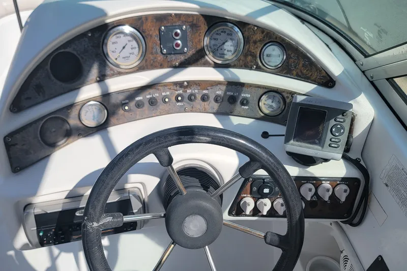 Slide: The Image of 2001 Hurricane SunDeck 217 OB boat dashboard with steering wheel and gauges. - 20