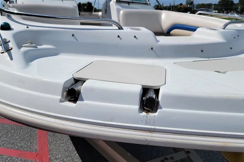Slide: The Image of 2001 Hurricane SunDeck 217 OB boat, white deck detail, docked outdoors. - 8