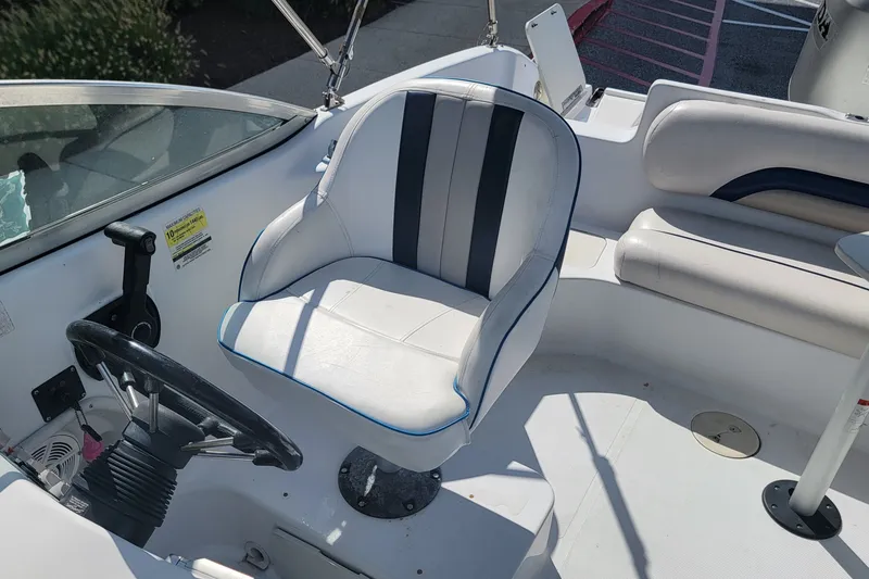 Slide: The Image of 2001 Hurricane SunDeck 217 OB boat interior with steering wheel and seating. - 16