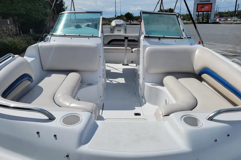 Slide: The Image of 2001 Hurricane SunDeck 217 OB boat interior with white seating and open deck layout. - 7