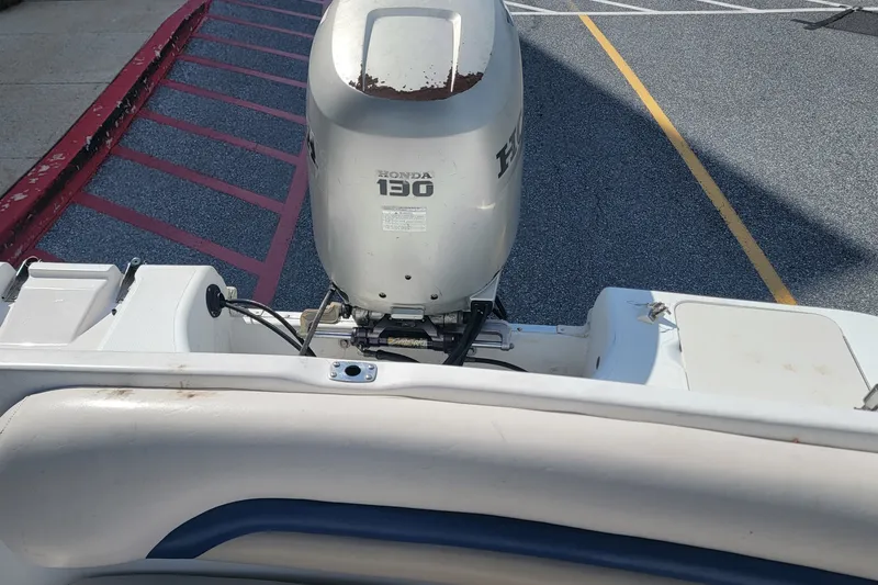 Slide: The Image of 2001 Hurricane SunDeck 217 OB with Honda 130 outboard motor in parking area. - 17