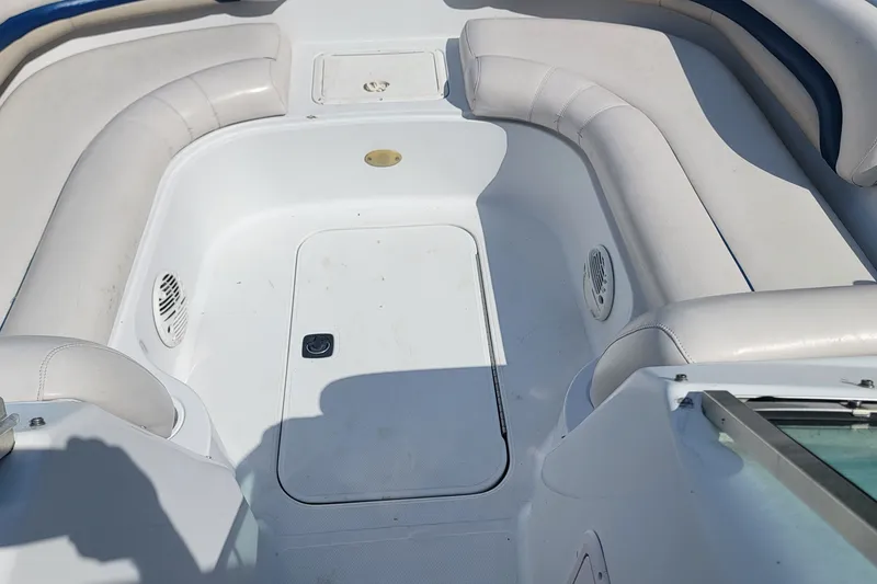 Slide: The Image of 2001 Hurricane SunDeck 217 OB boat interior with white seating and storage compartment. - 13
