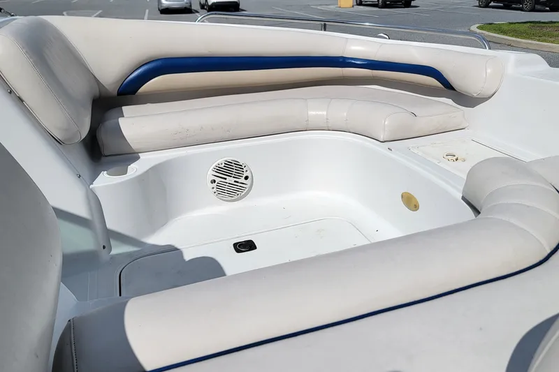 Slide: The Image of 2001 Hurricane SunDeck 217 OB boat interior with white seating and blue accents. - 9