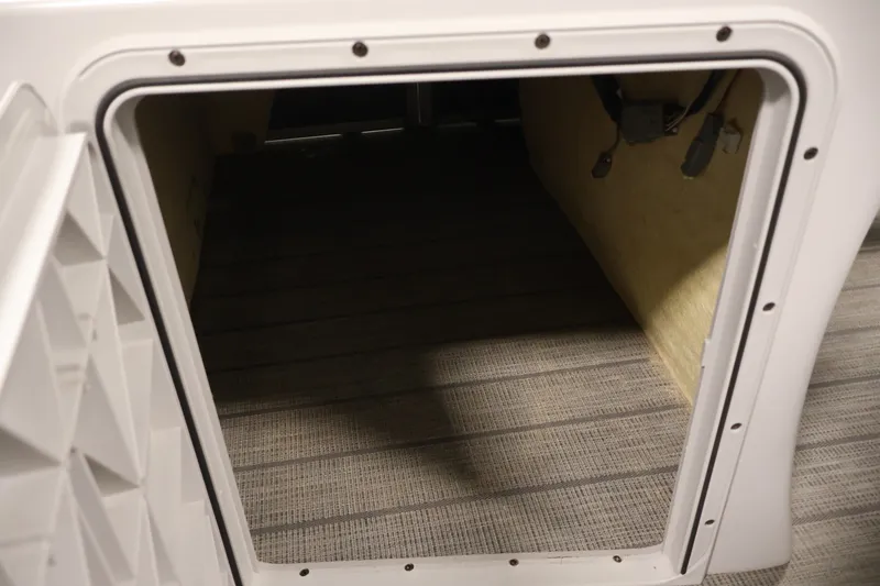 Slide: The Image of Open storage compartment in a 2021 Sweetwater 2086C boat, showing interior space. - 11