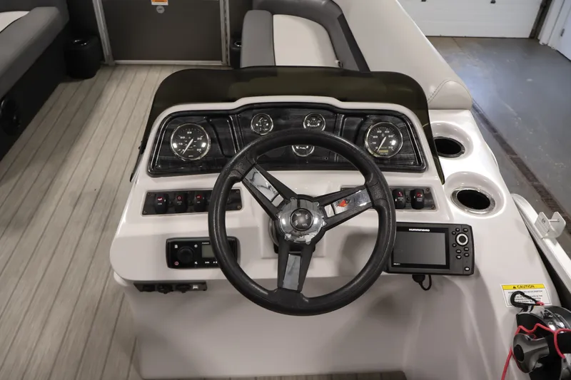 Slide: The Image of Steering console of a 2021 Sweetwater 2086C boat with gauges and controls. - 12