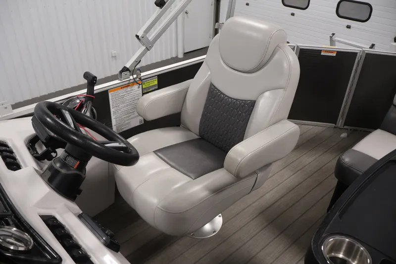 Slide: The Image of Captain's chair and steering wheel of 2021 Sweetwater 2086C boat, featuring modern design. - 20