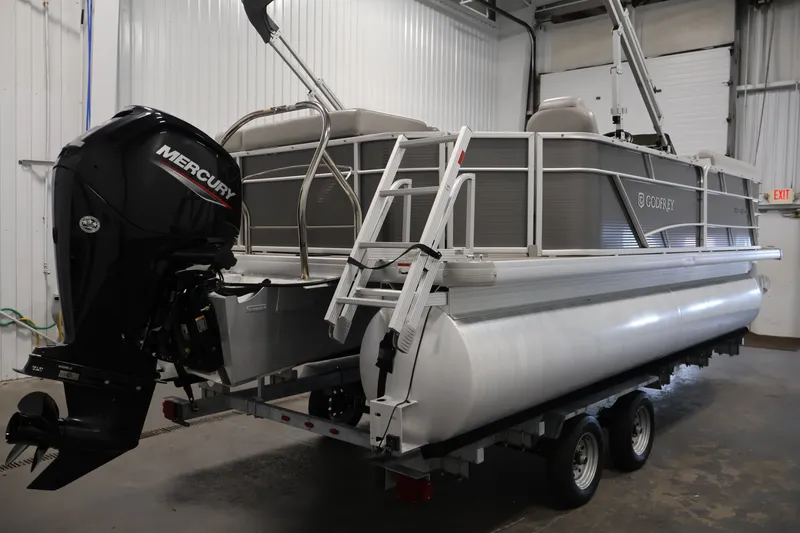 Slide: The Image of 2021 Sweetwater 2086C pontoon boat with Mercury outboard motor in a garage. - 4