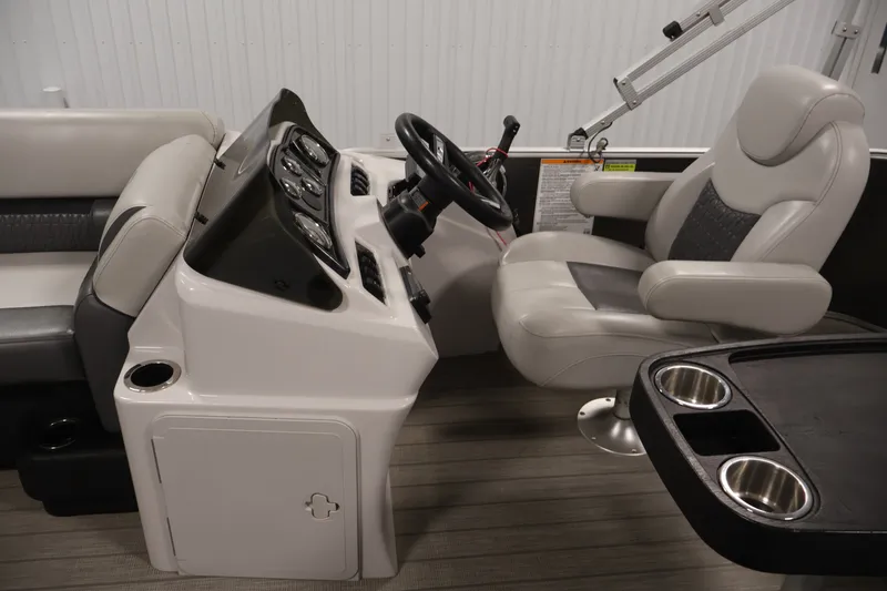 Slide: The Image of Interior of a 2021 Sweetwater 2086C boat with steering console and seating. - 10