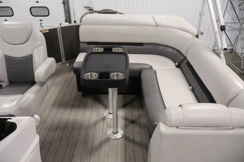 Slide: The Image of Luxurious Sweetwater 2086C pontoon interior with plush seating and table, 2021 model. - 21