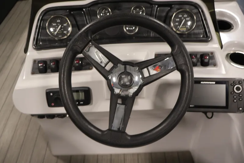 Slide: The Image of Steering console of 2021 Sweetwater 2086C boat with gauges and navigation system. - 13