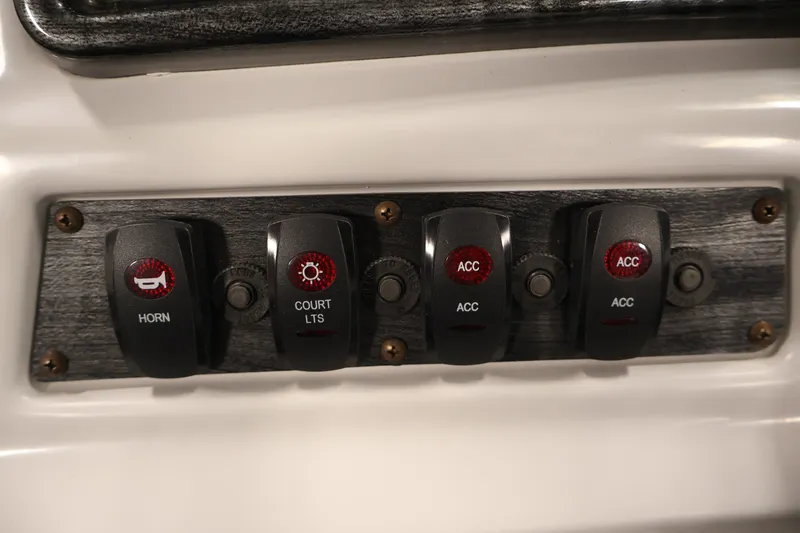 Slide: The Image of Control panel of a 2021 Sweetwater 2086C boat with labeled switches. - 15