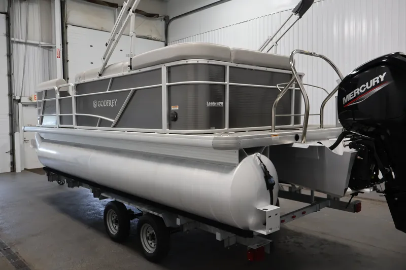Slide: The Image of Pontoon boat in garage, Sweetwater 2086C 2021 model, with Mercury outboard motor. - 6