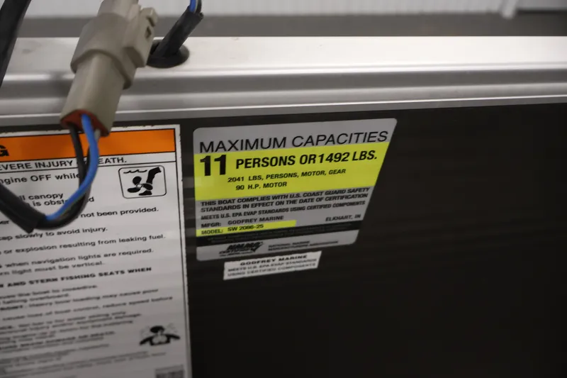 Slide: The Image of Maximum capacity label on 2021 Sweetwater 2086C boat, 11 persons or 1492 lbs. - 19