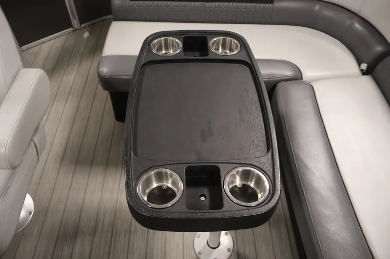 Slide: The Image of 2021 Sweetwater 2086C boat interior with table and cup holders. - 25