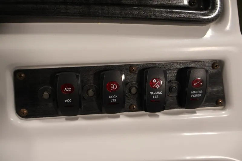 Slide: The Image of Control panel of a 2021 Sweetwater 2086C boat with labeled switches. - 16