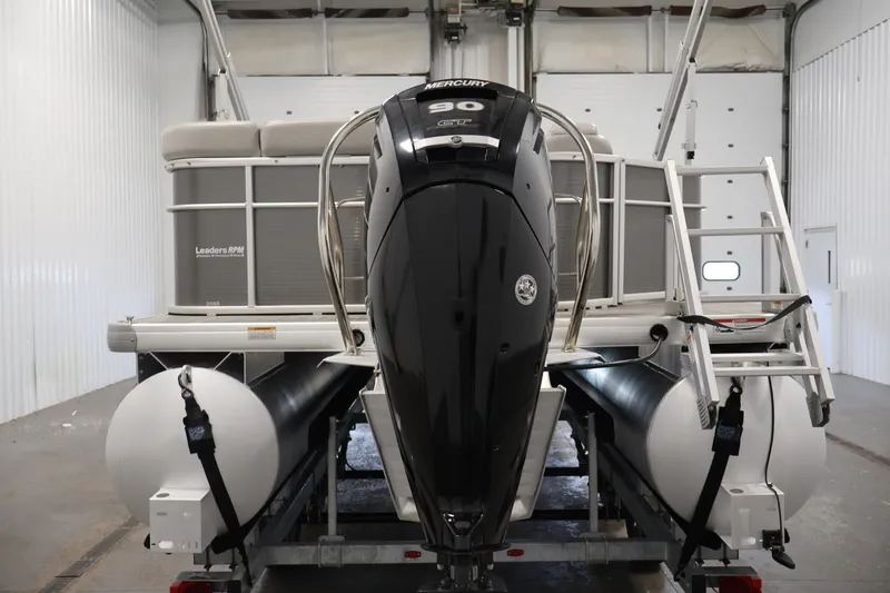 Slide: The Image of 2021 Sweetwater 2086C pontoon boat with Mercury outboard motor in a garage. - 5