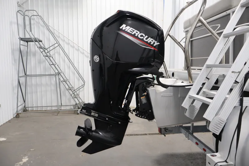 Slide: The Image of Sweetwater 2086C 2021 boat with Mercury outboard motor in a garage setting. - 32
