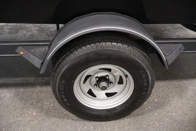 Slide: The Image of Trailer wheel and fender of a 2022 Tahoe T18 boat. - 40