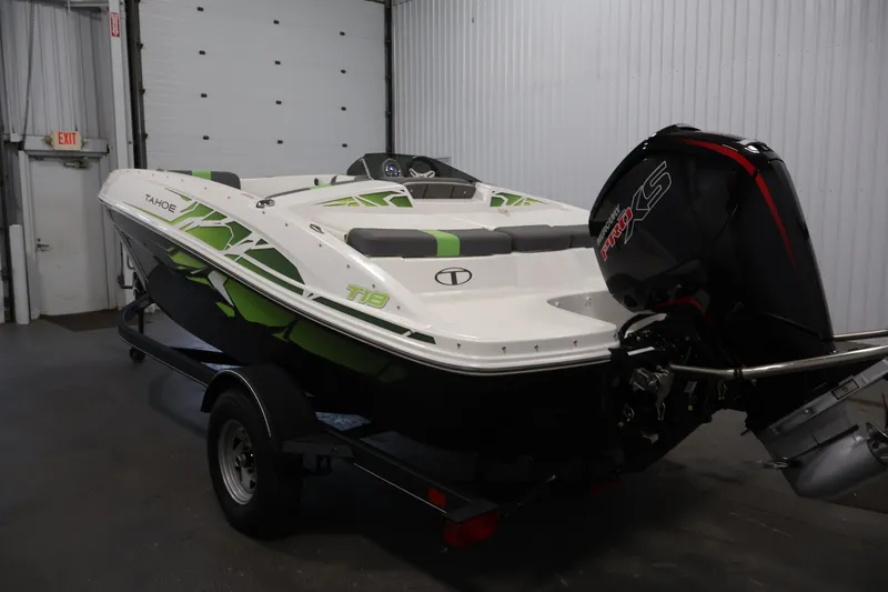 Slide: The Image of 2022 Tahoe T18 boat with outboard motor in a garage setting. - 6