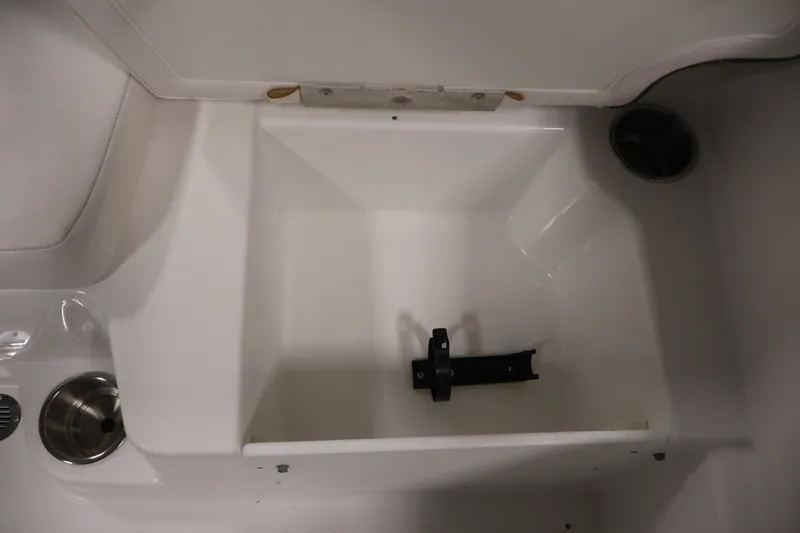 Slide: The Image of 2022 Tahoe T18 boat storage compartment with cup holder and mounting bracket. - 23
