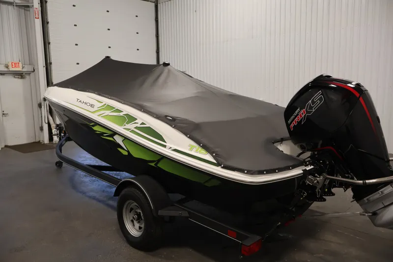 Slide: The Image of 2022 Tahoe T18 boat with cover and Mercury Pro XS engine in a garage. - 41