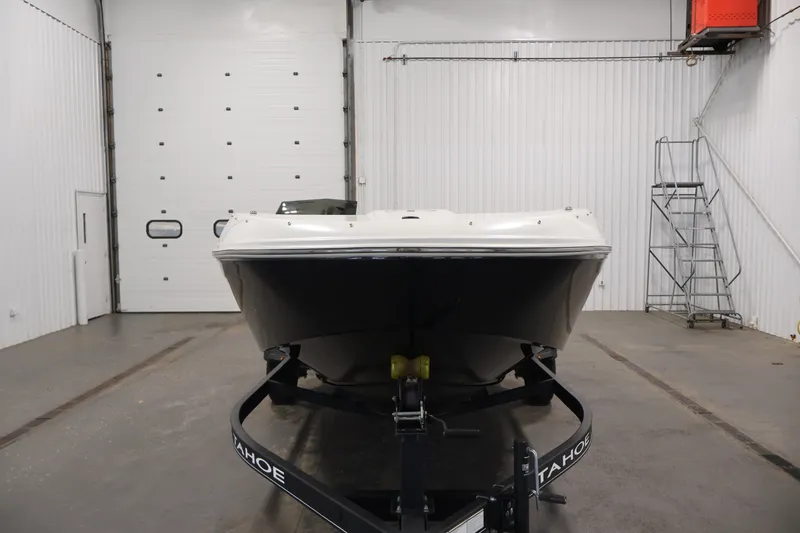 Slide: The Image of 2022 Tahoe T18 boat on trailer in a spacious indoor garage. - 1