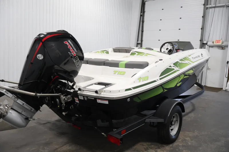 Slide: The Image of 2022 Tahoe T18 boat with Mercury Pro XS engine in a garage setting. - 4