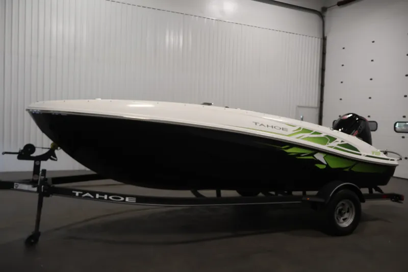Slide: The Image of 2022 Tahoe T18 boat on trailer in indoor setting, featuring sleek design and vibrant accents. - 7