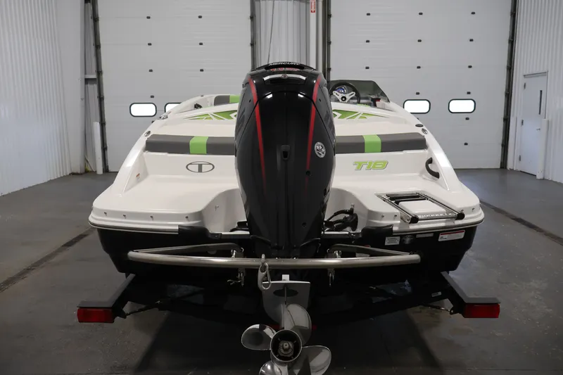 Slide: The Image of 2022 Tahoe T18 boat in garage, rear view with outboard motor. - 5