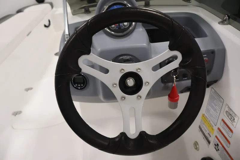 Slide: The Image of Steering wheel of 2022 Tahoe T18 boat, featuring modern dashboard controls. - 15