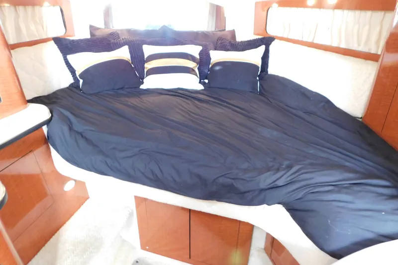 Slide: The Image of Luxurious cabin interior of 2001 Sea Ray 300 Sundancer with cozy bedding and pillows. - 46