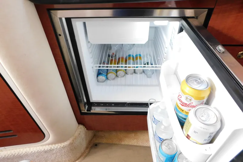 Slide: The Image of Mini fridge stocked with beverages inside a 2001 Sea Ray 300 Sundancer boat. - 55