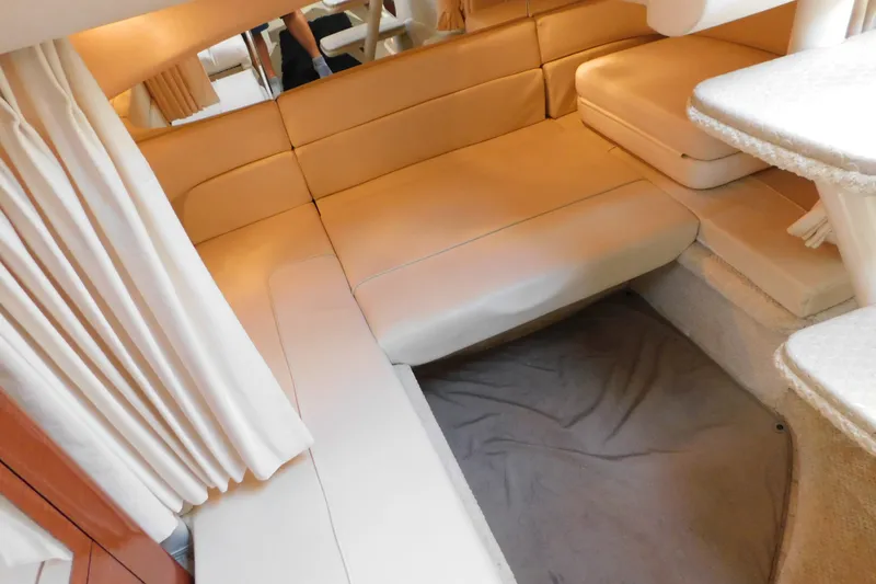 Slide: The Image of Interior of 2001 Sea Ray 300 Sundancer with beige seating and curtains. - 44